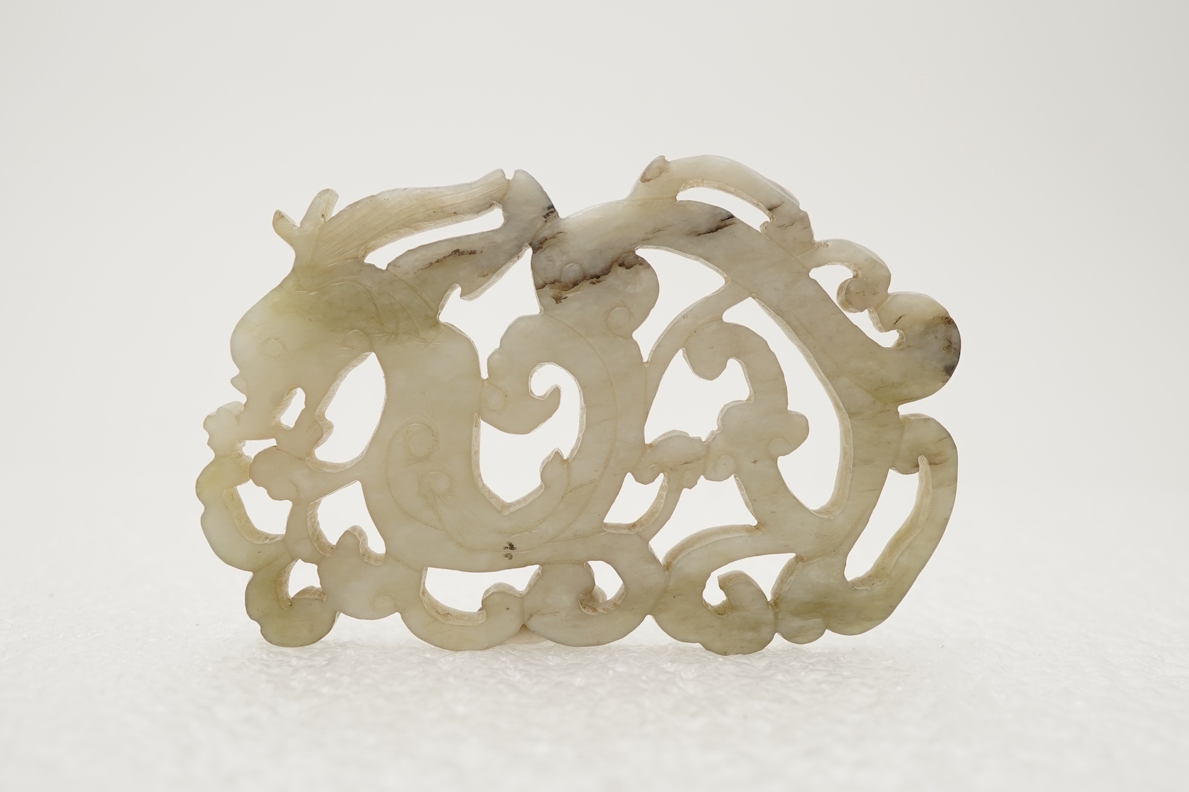 A Chinese white and grey mottled jade ‘chilong’ plaque, Ming dynasty